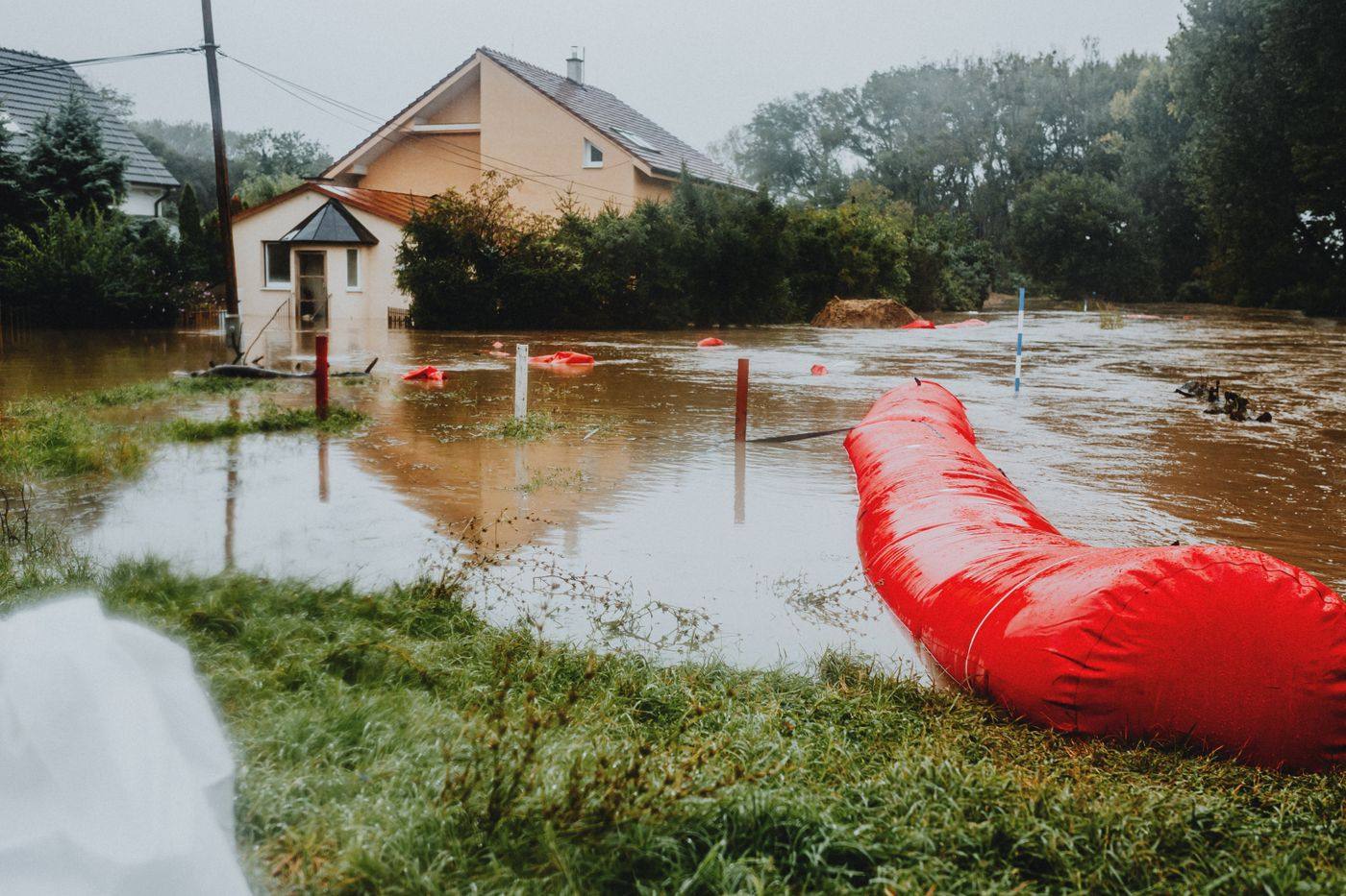 A flooded street with barriers after a storm