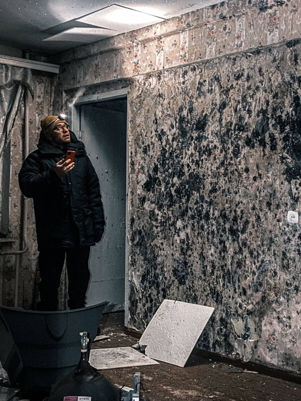 Mold-covered walls being inspected