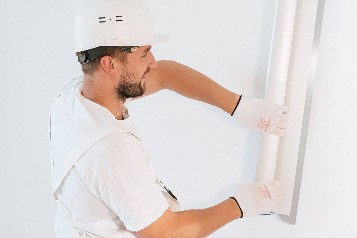 A worker installing drywall